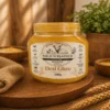 A 500g jar of textured golden Desi Ghee with a Field N Feather label, featuring farm animal illustrations and organic certifications.